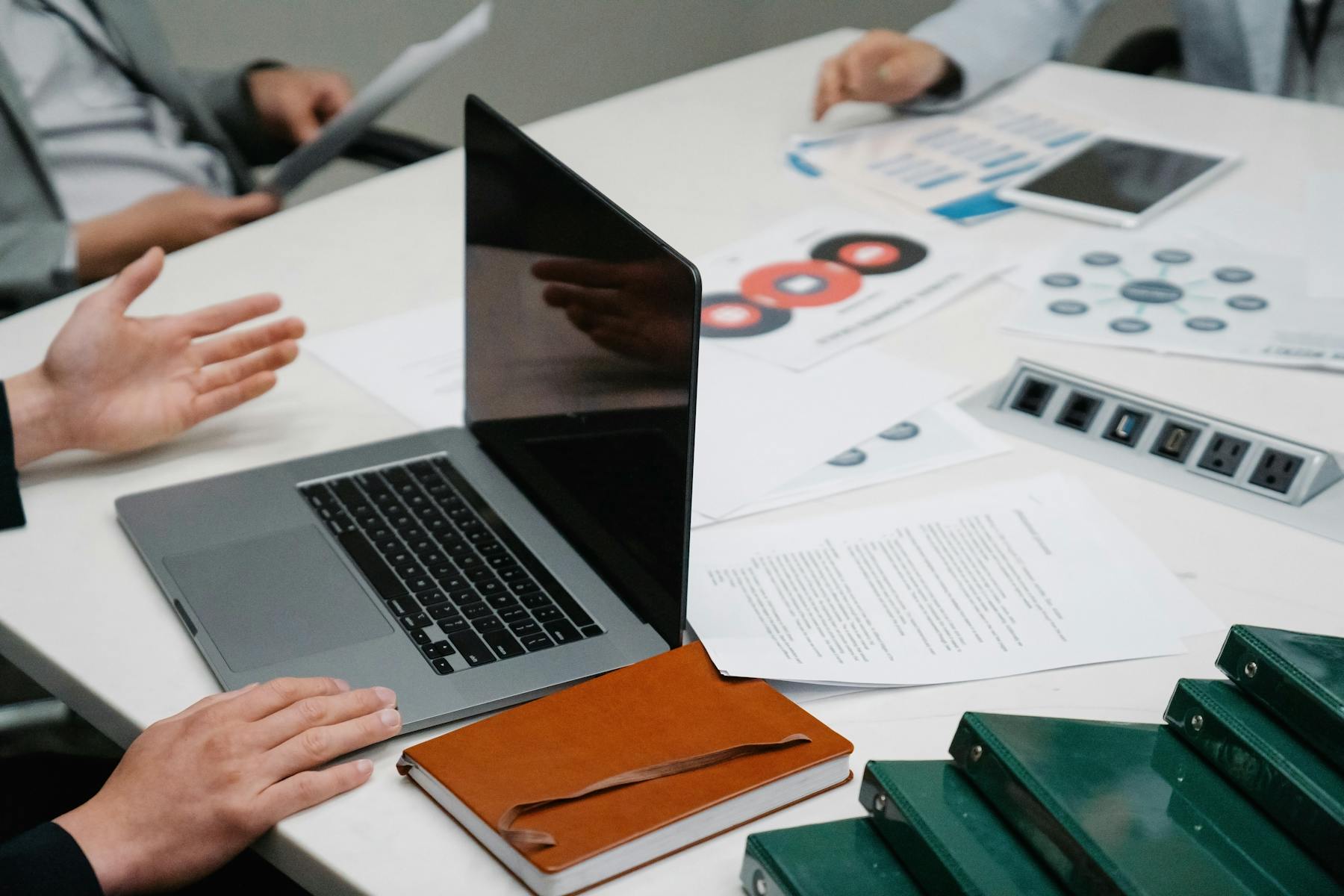 Business operators reviewing documents and laptop work