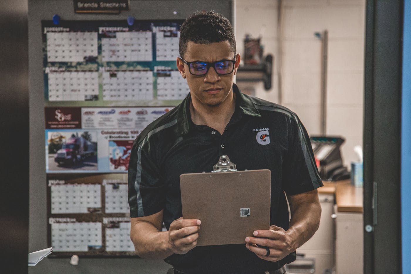 Operator checking a clipboard inside a warehouse